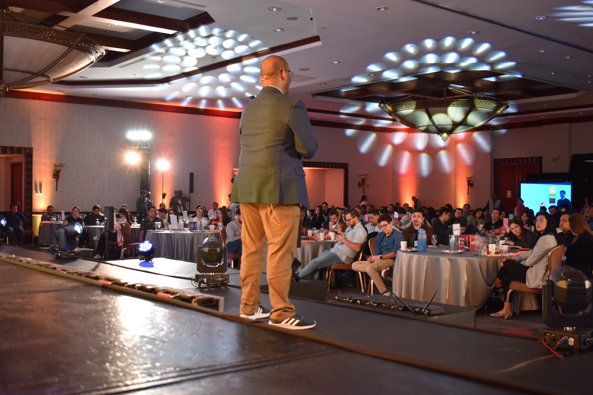 Hermes Ruiz speaking to a full auditorium